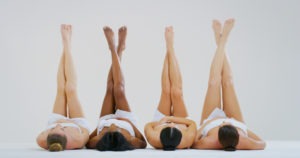 four women with smooth skin in various tones